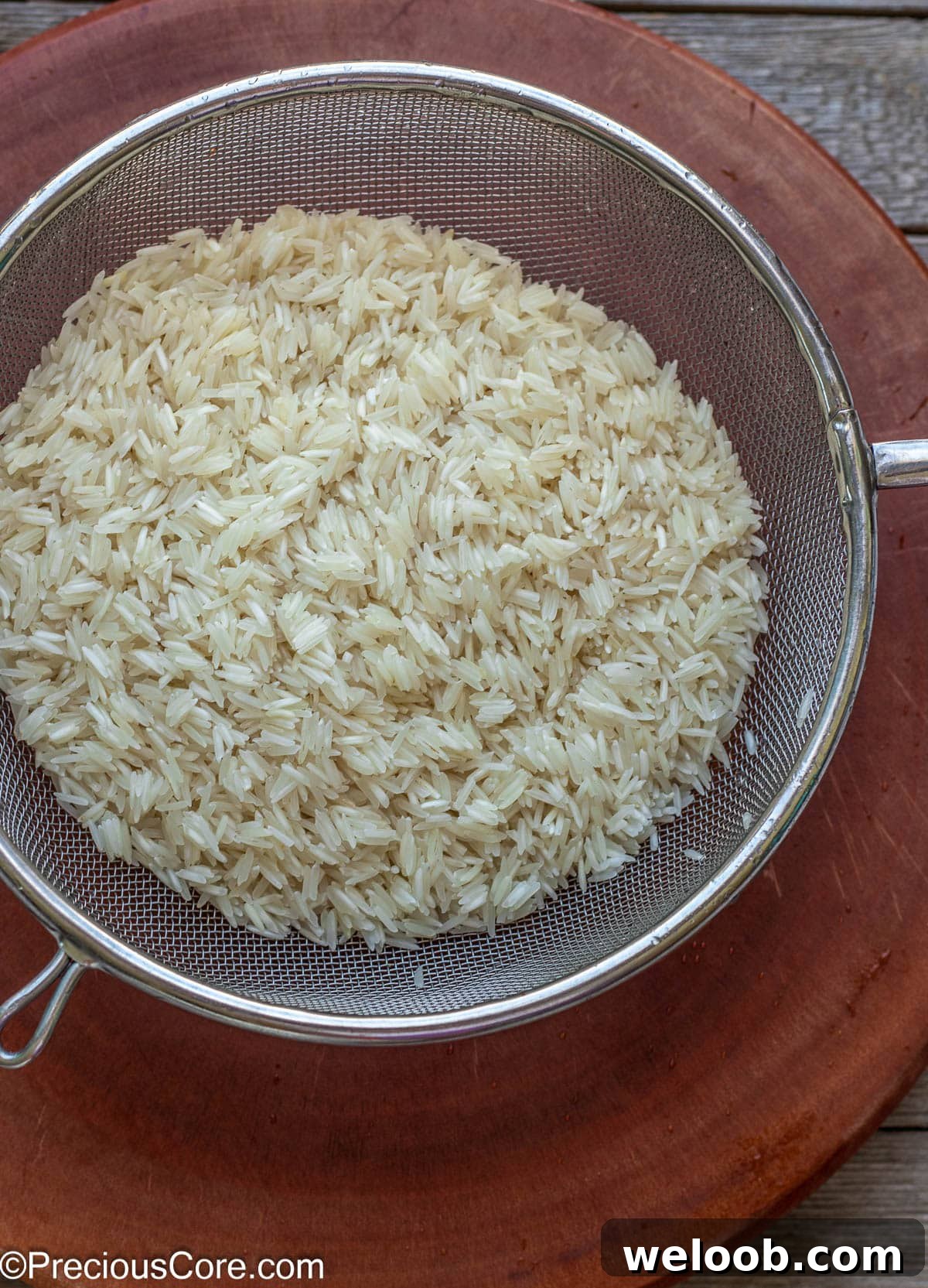 Rinsed rice in a fine mesh strainer.