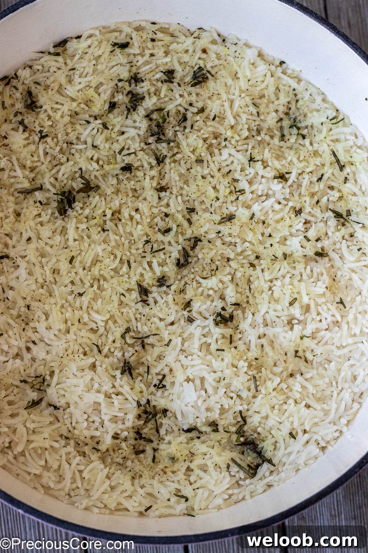 Cooked rice with garlic and herbs in a pot.