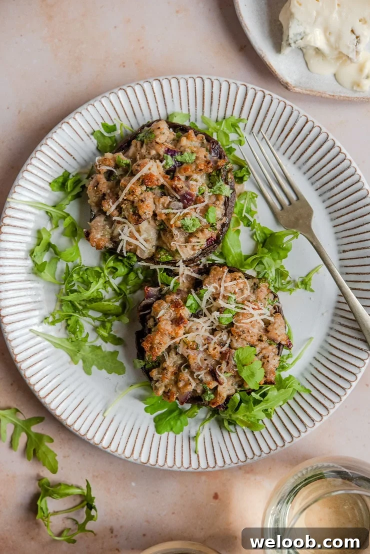 An overhead shot of sausage stuffed mushrooms on a rustic plate