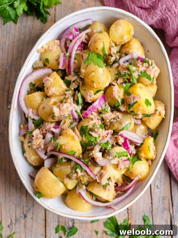 An overhead shot of a tuna potato salad in a large serving bowl