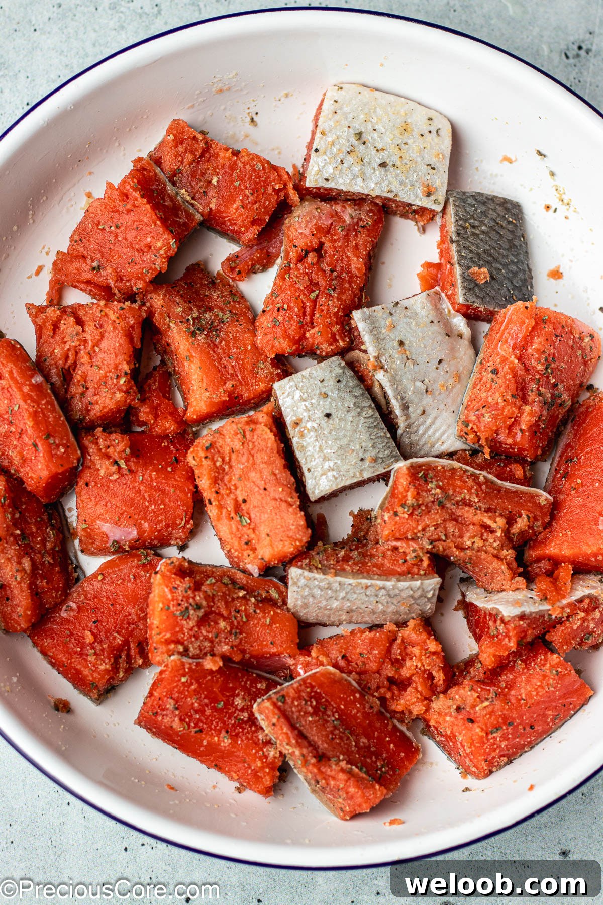 Seasoned salmon in a bowl.