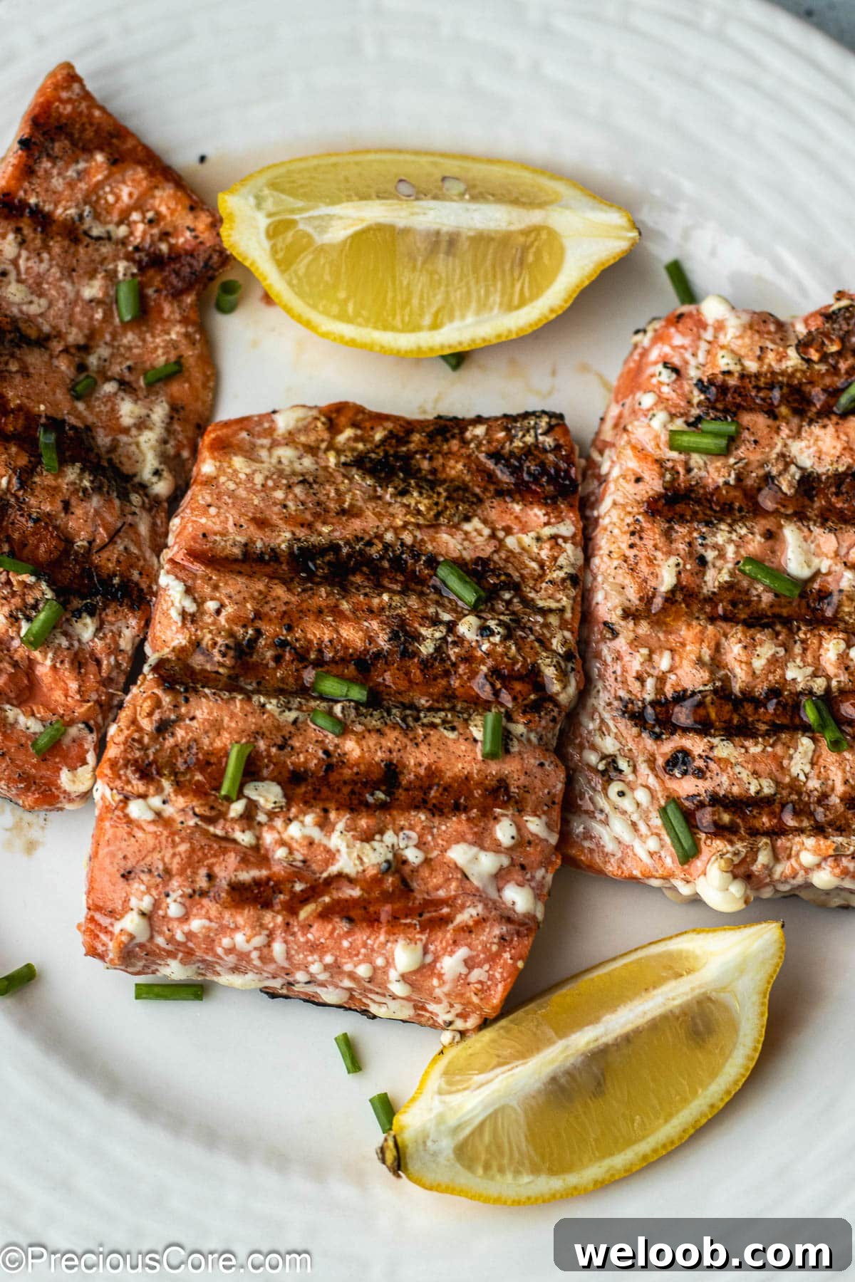 Grilled Sockeye Salmon steaks on a white plate.