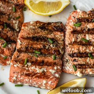 Grilled Sockeye Salmon steaks on a white plate.