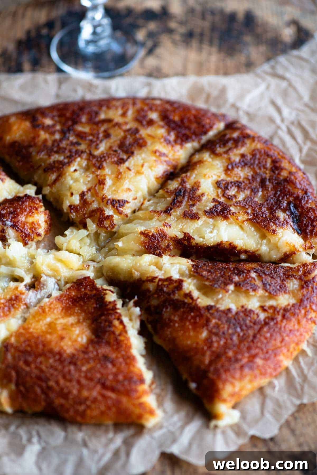 Frico (fried cheese and potato) on a wooden surface.