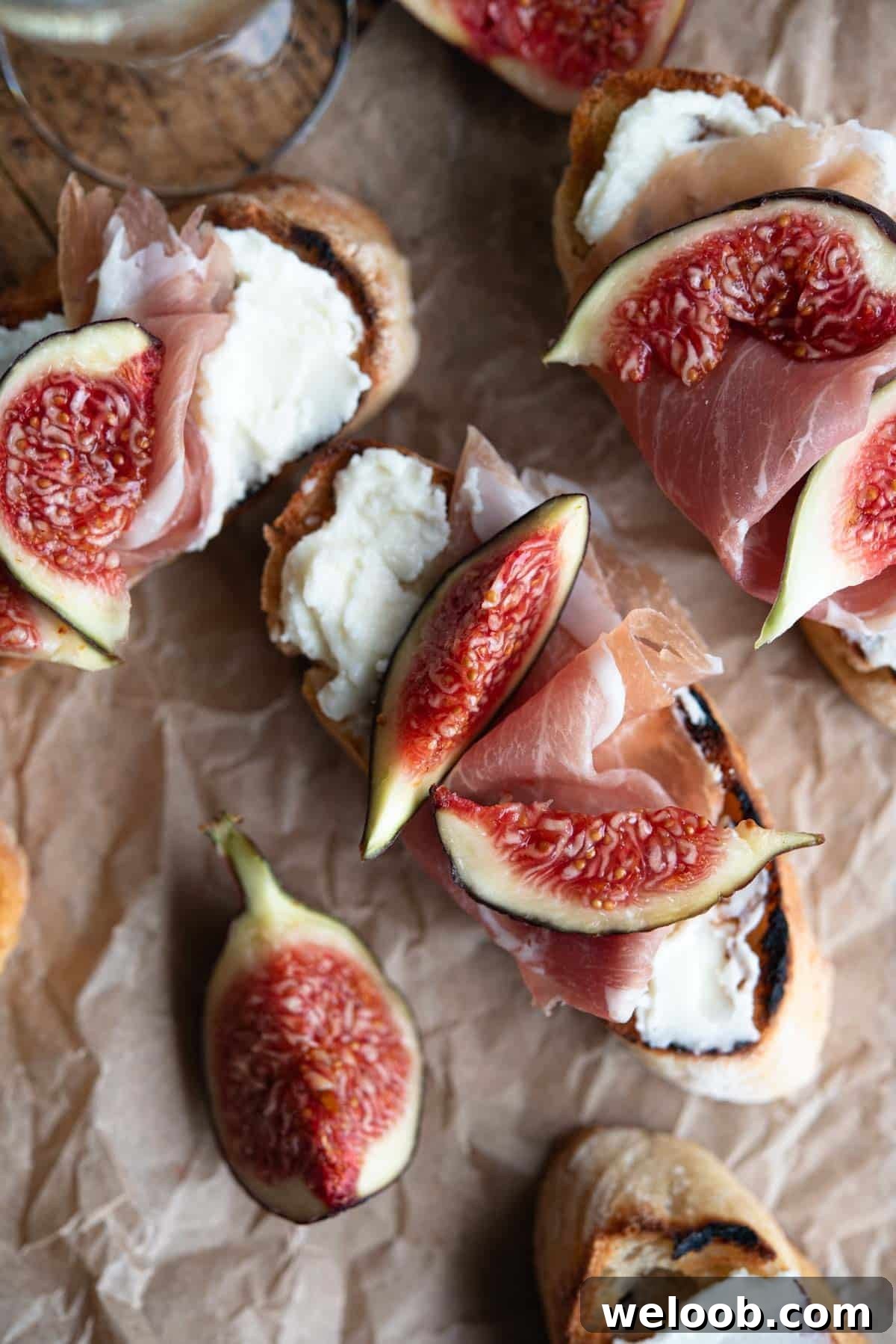 An overhead shot of crostini with figs, pecorino cream and prosciutto.