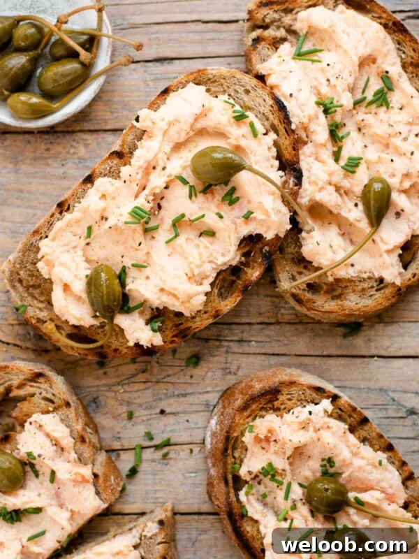 An overhead shot of smoked salmon crostini on a wooden surface