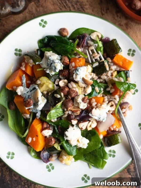 An overhead shot of a warm farro salad with butternut squash, spinach and gorgonzola.