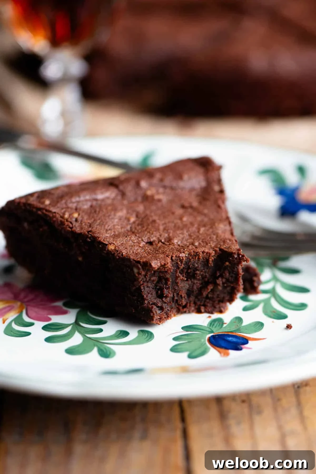 A close up of a slice of Italian chocolate cake on a plate with a fork.
