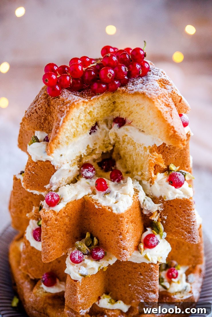 A close up of a pandoro christmas tree cake with a slice missing