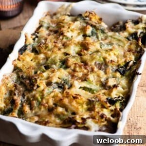 A closeup cropped image of a cheese and cabbage casserole in a baking dish.
