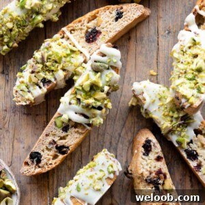 A close up of pistachio biscotti with cranberries and white chocolate