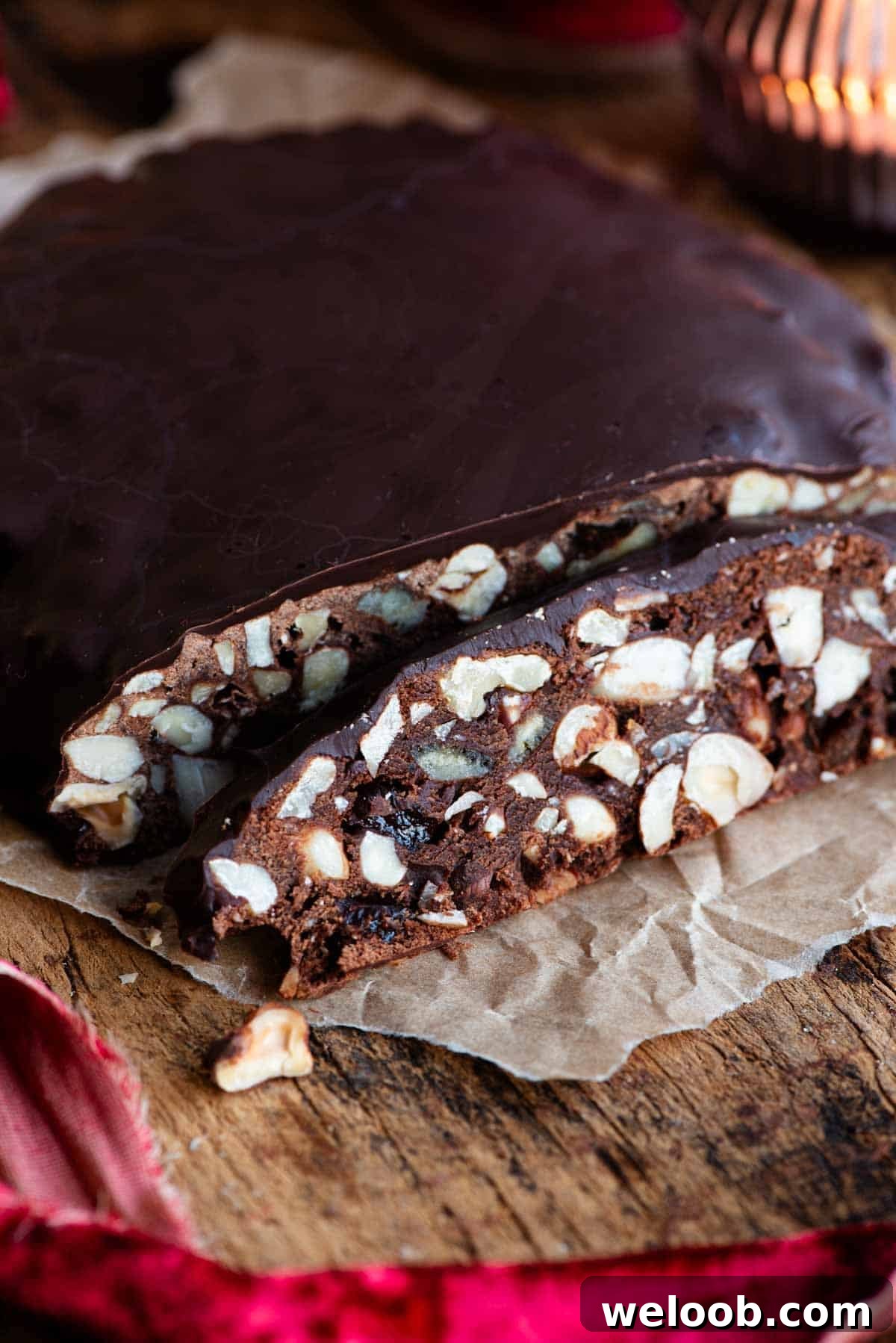 A close up of a slice of Panpepato filled with nuts and dried fruit.