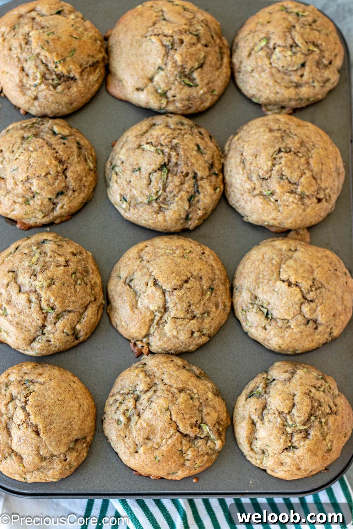 Baked zucchini muffins with applesauce in muffin tin.