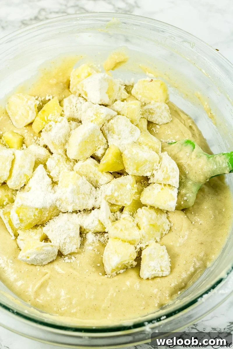 Chunks of apple on cake batter.