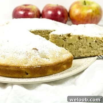 Apple cake with a slice being removed.