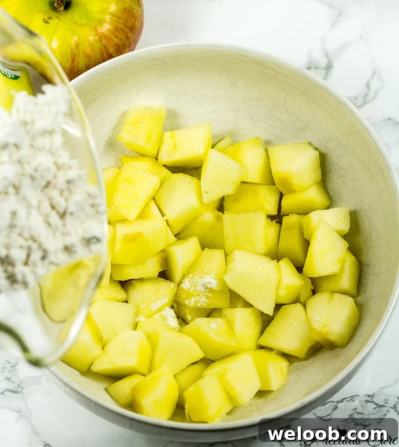 Adding flour to apple chunks.