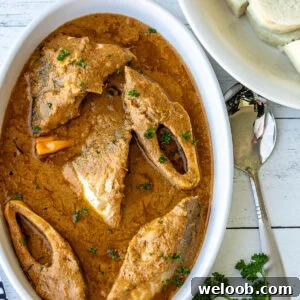 Njangsa Sauce Recipe from Cameroon: How to Make Authentic Njansa Stew 7 Njangsa sauce in a white oval bowl with white yams on the side.