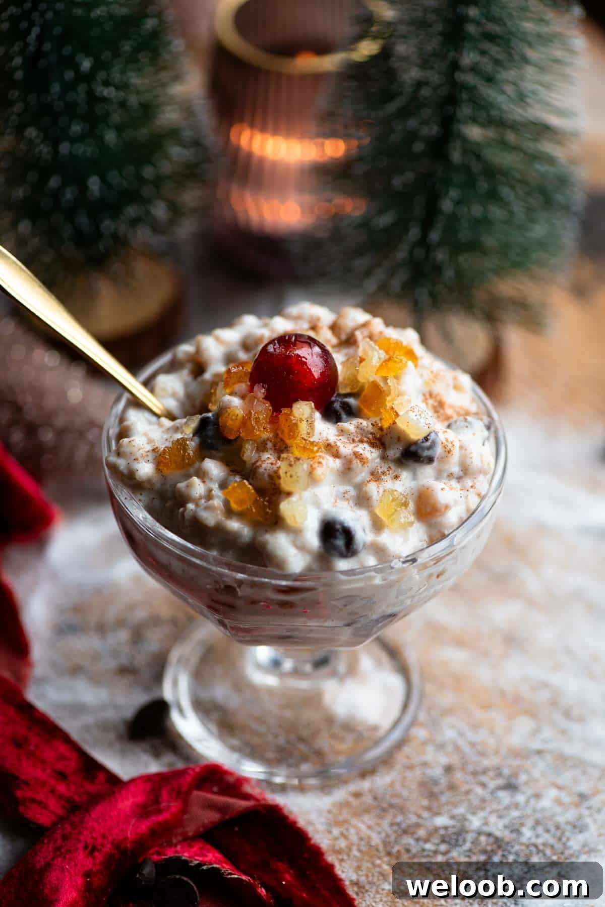 A Sicilian dessert made with ricotta, grain and candied fruit in a glass serving dish topped with a candied cherry.