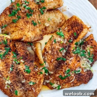 Lemon butter tilapia fillets on a plate