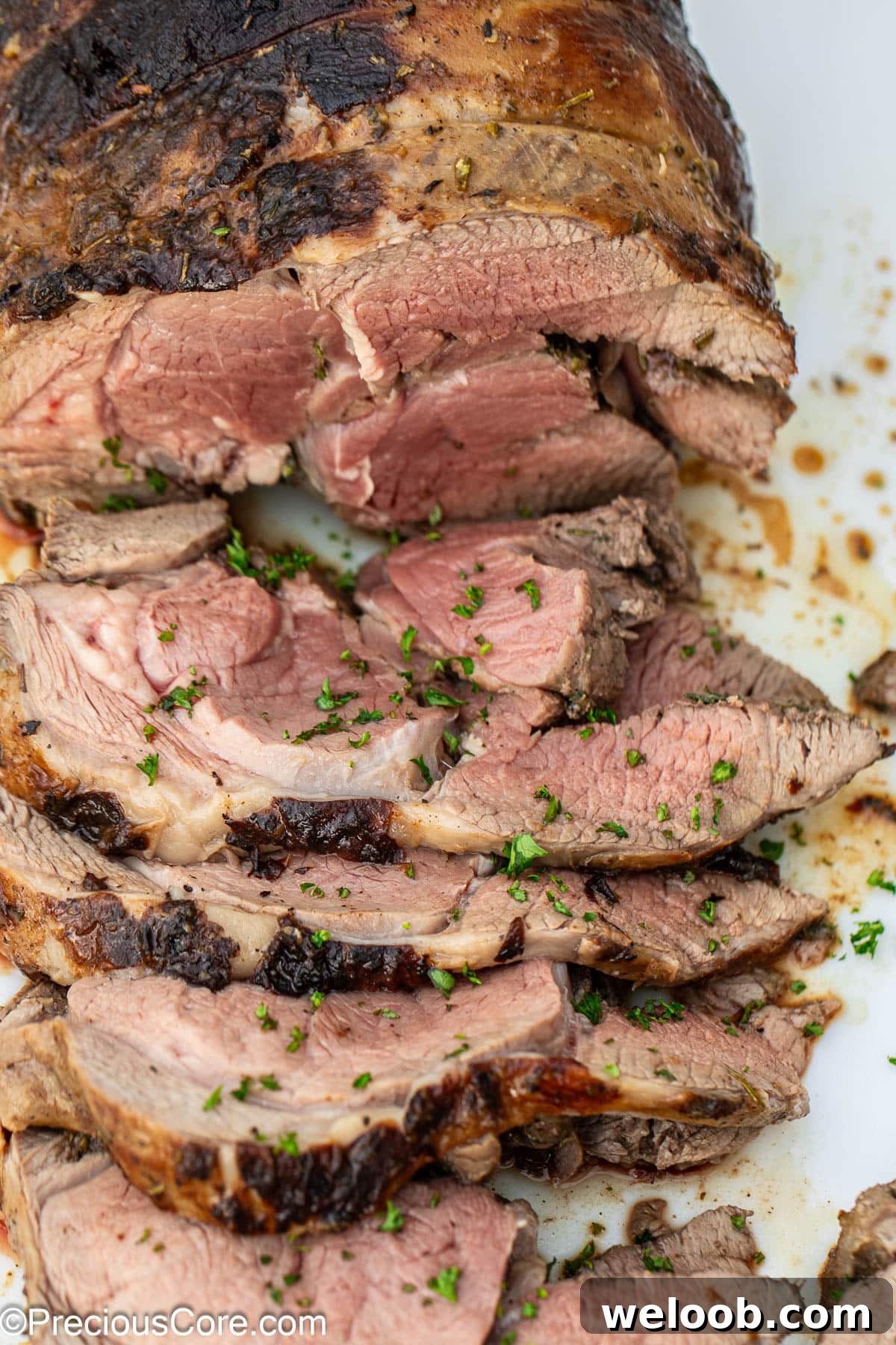 A sliced roasted boneless leg of lamb.
