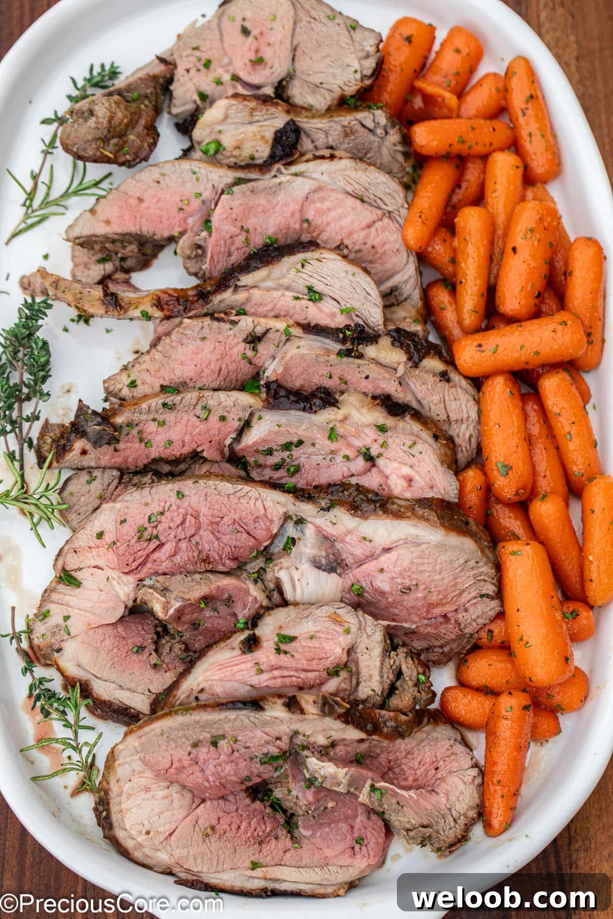 Sliced roast and glazed carrots on white tray.