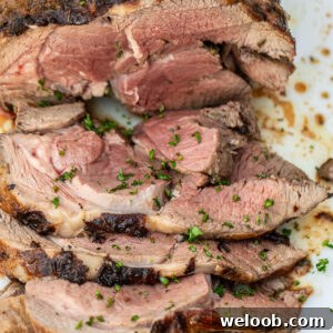 A sliced roasted boneless leg of lamb.