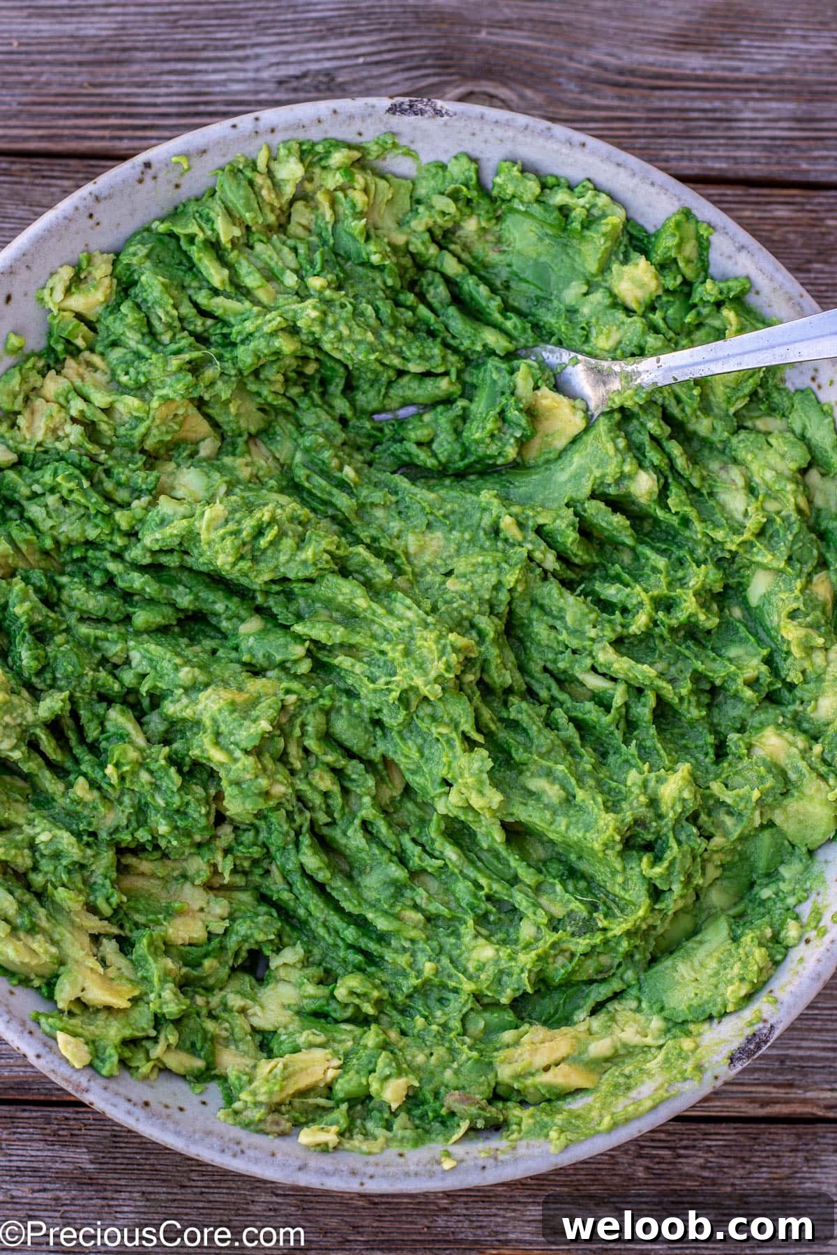Mashed avocados in a bowl.