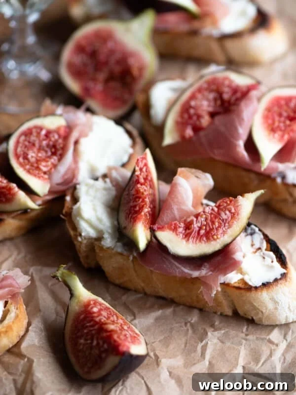 A close up of fig crostini with pecorino cream and prosciutto.