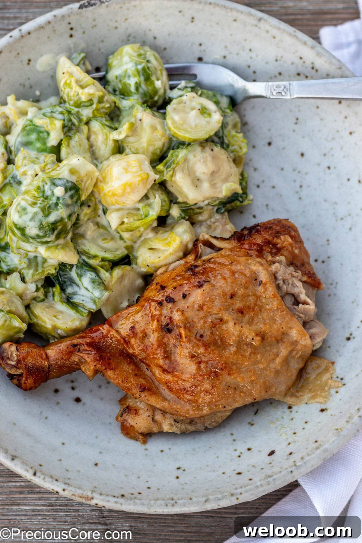 Duck in a bowl with brussels sprouts.
