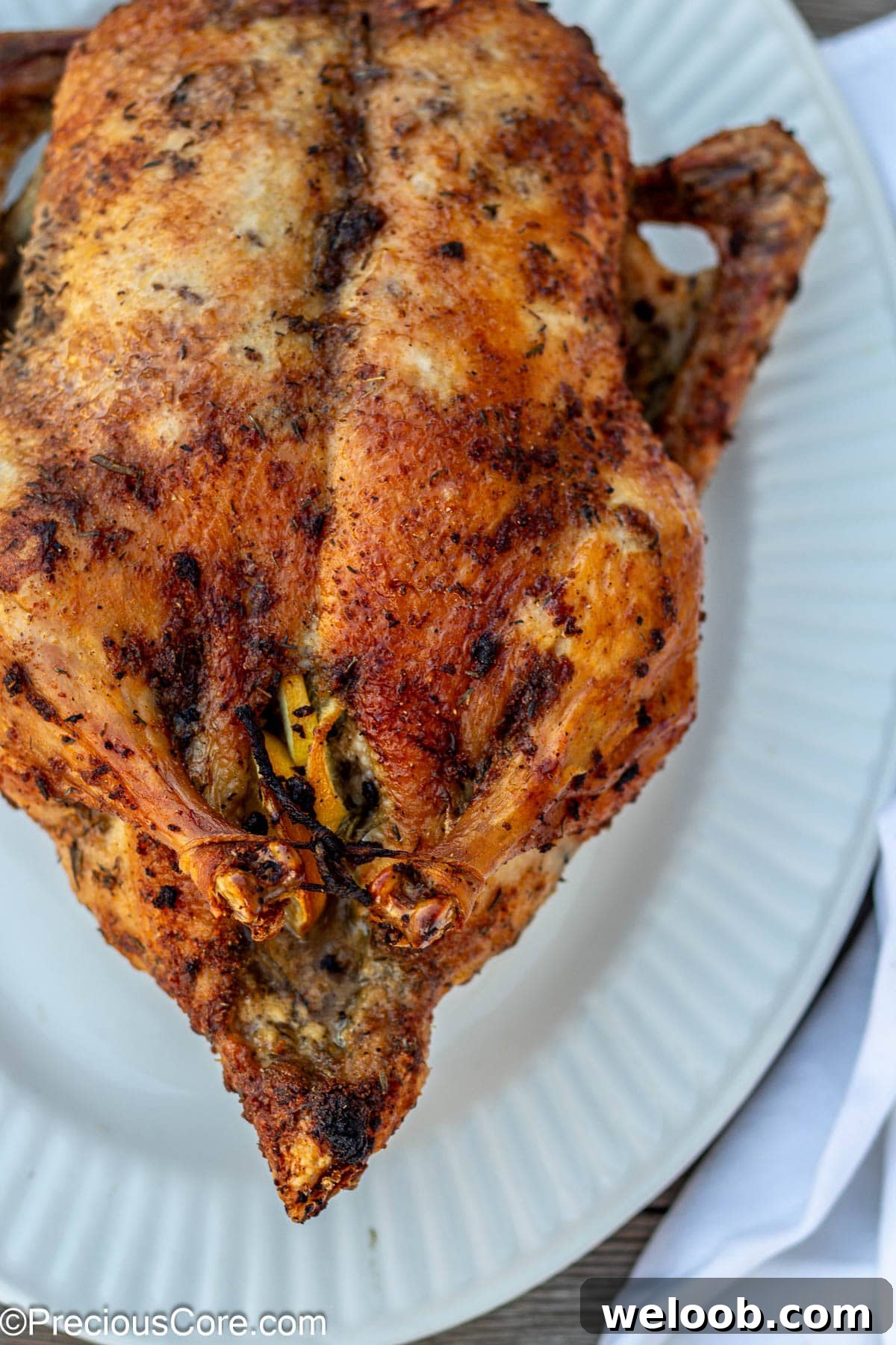 Herb roasted duck on white tray.