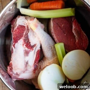 A cropped image showing all the ingredients for an Italian meat broth in a stock pot.