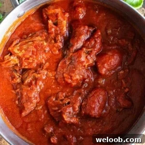 A square cropped image of ragu alla napoletana in a large pot.