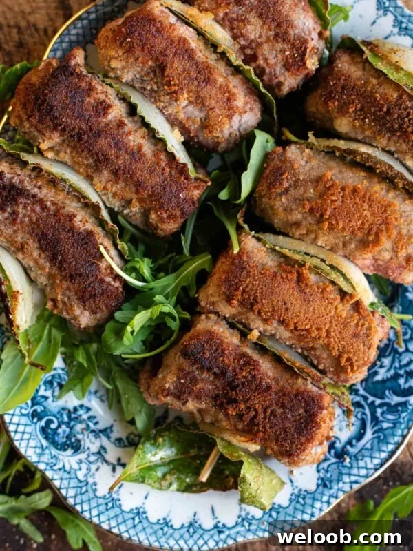 An overhead shot of Sicilian involtini on skewers with breadcrumbs.