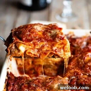 A cropped close up image of a slice of Neapolitan lasagna.