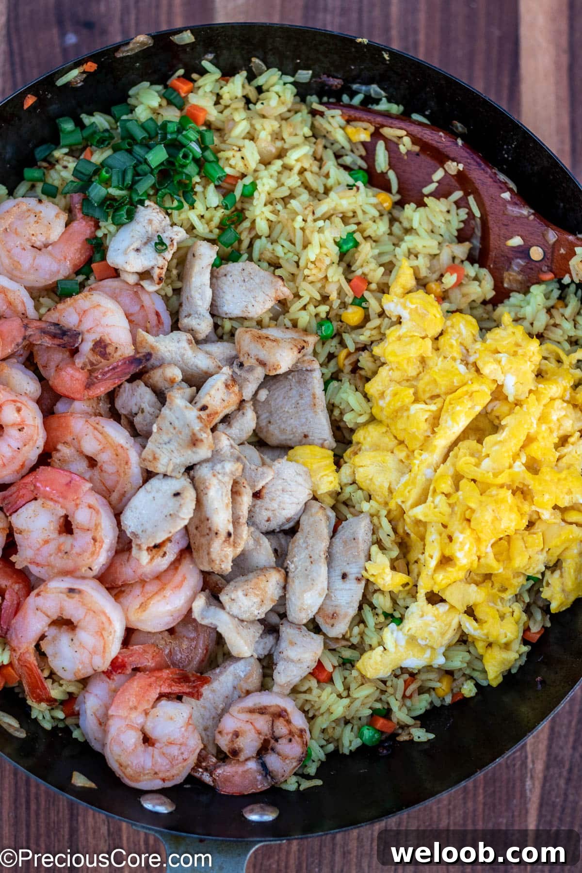 Fried rice topped with shrimp and chicken.