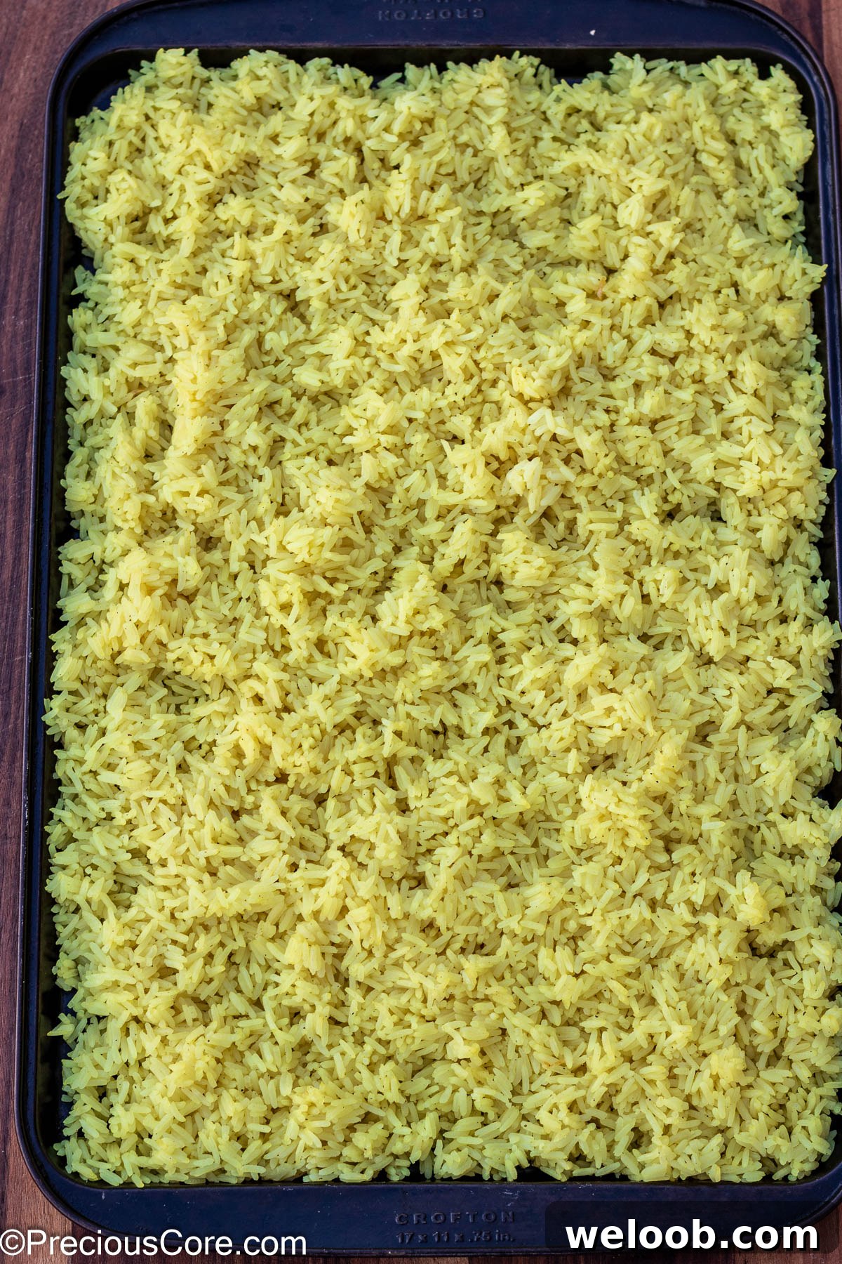Cooked rice spread on a tray.