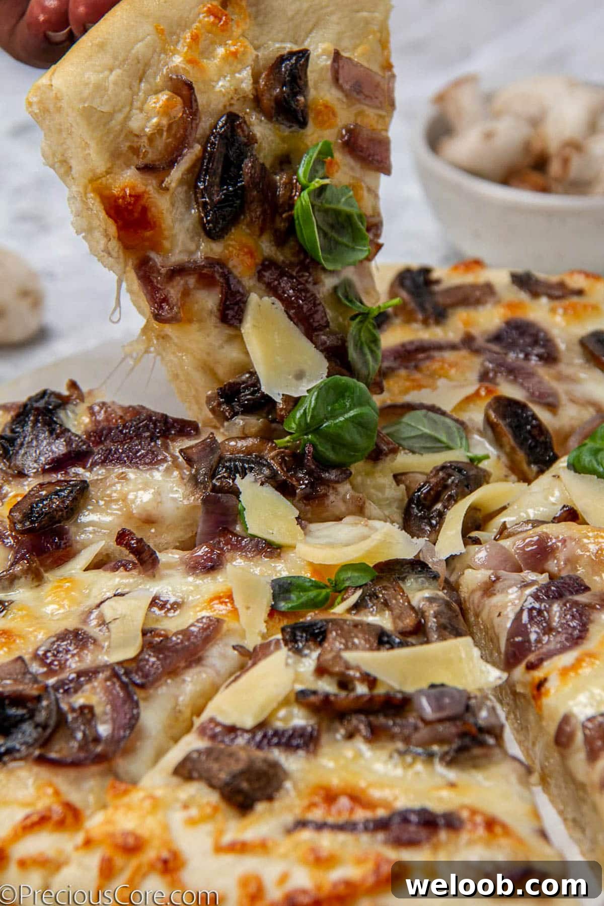Grabbing a slice of mushroom pizza.