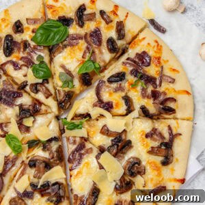 Pizza topped with mushrooms and fresh basil.