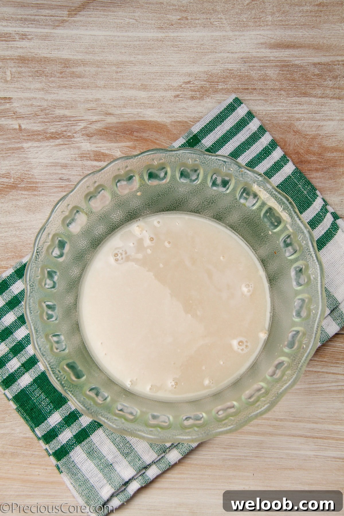 Yeast dissolved in a bowl of warm water.