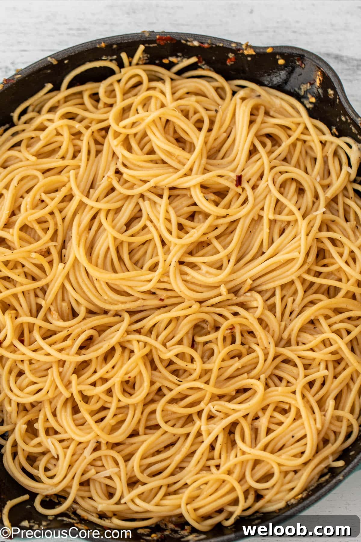Tossed spaghetti in garlic butter sauce.