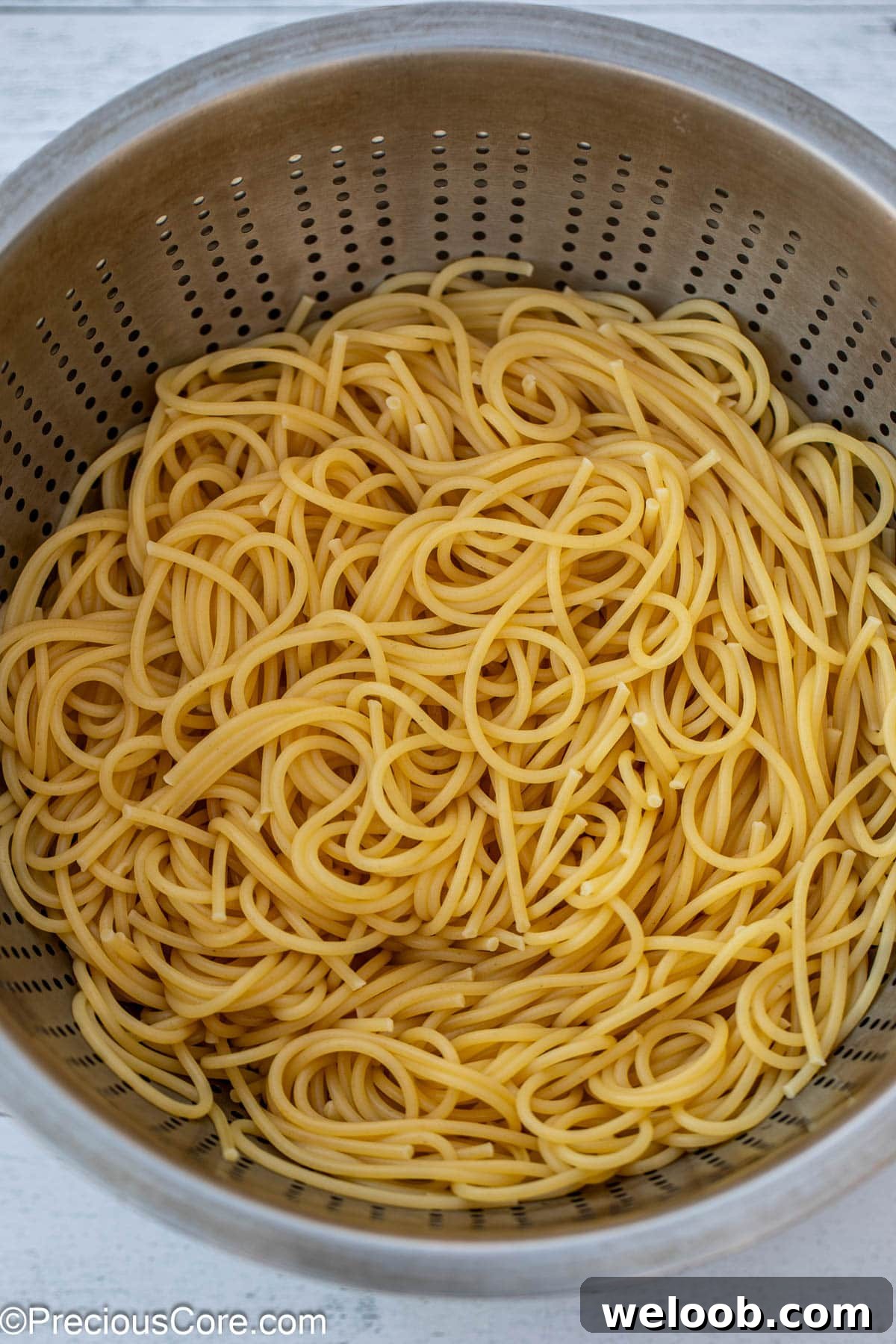 Cooked and strained spaghetti in a colander.