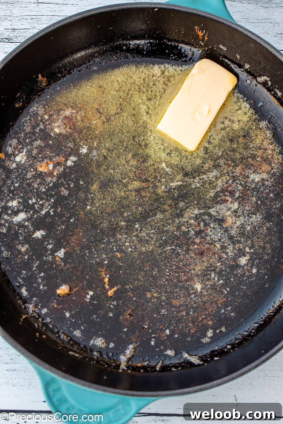Butter melting in a cast iron skillet.