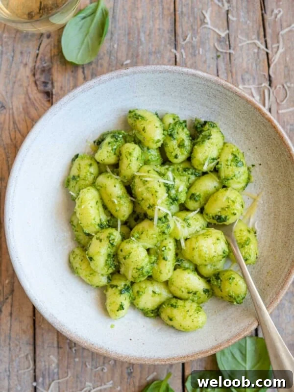An overhead shot of pesto gnocchi in a bowl