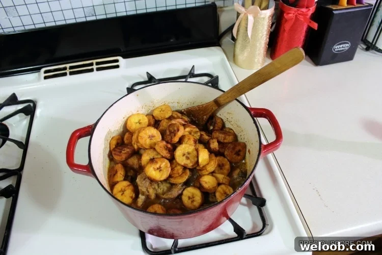 Poulet DG Recipe: How to Make Cameroon’s Classic Chicken Dish 14 Plantains in a red Dutch oven with chicken.