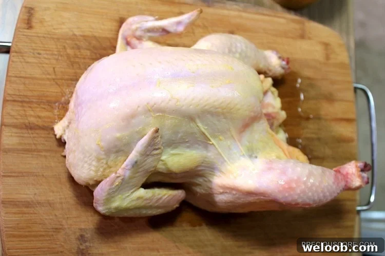 Poulet DG Recipe: How to Make Cameroon’s Classic Chicken Dish 6 Whole chicken on a wooden cutting board.