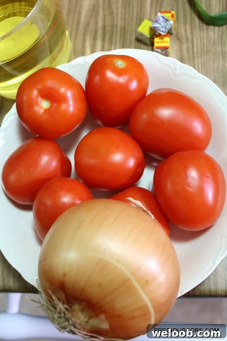 Poulet DG Recipe: How to Make Cameroon’s Classic Chicken Dish 7 Tomatoes and onion in a bowl.