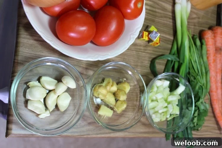 Poulet DG Recipe: How to Make Cameroon’s Classic Chicken Dish 8 Bowls of ingredients including tomatoes, garlic, and ginger.