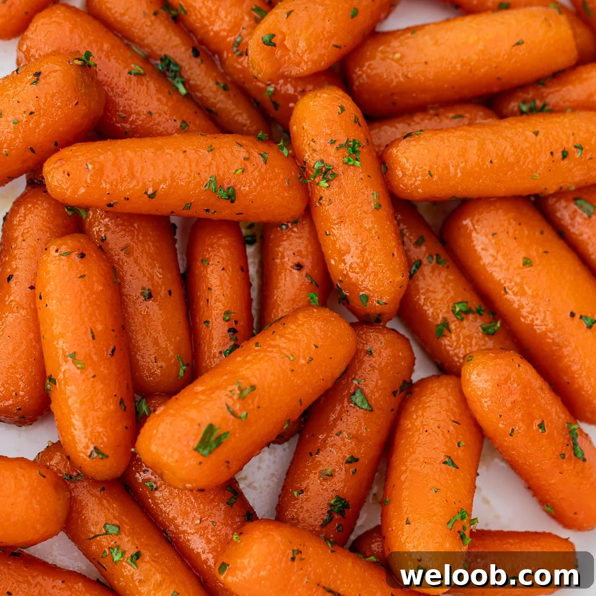 Square image of glazed carrots.