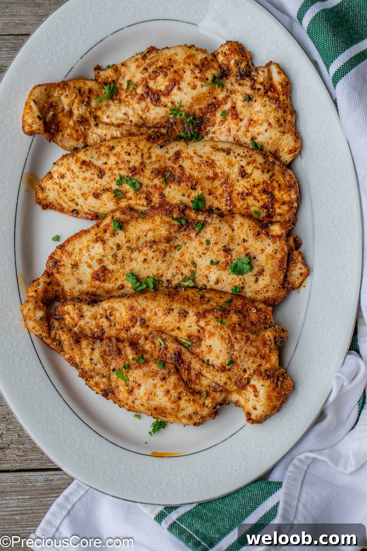 Cooked chicken on white serving plate.