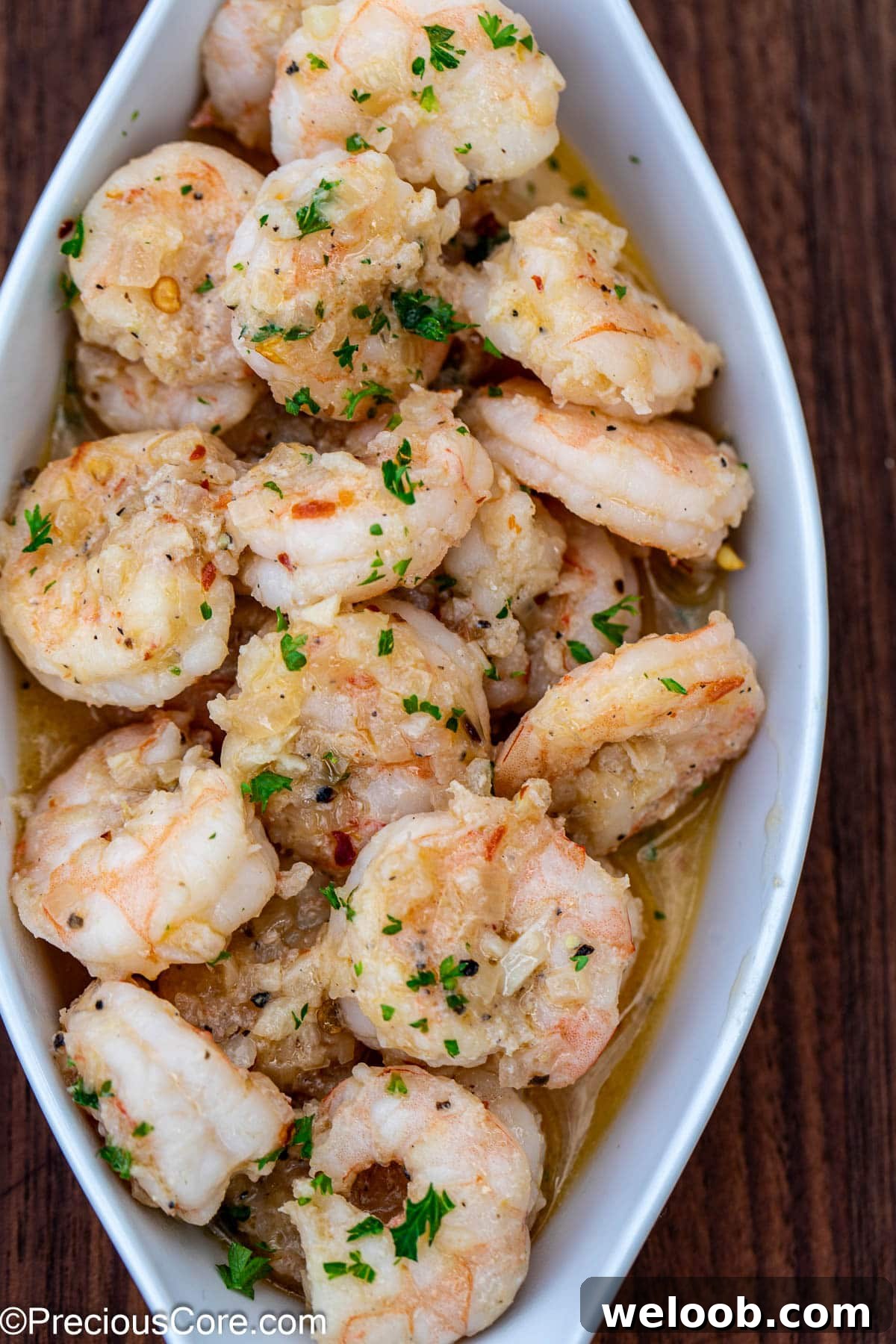 A serving of shrimp in white wine sauce.